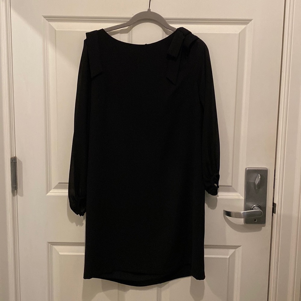 Black dress   Bow detail on shoulder. Sheer sleeves.